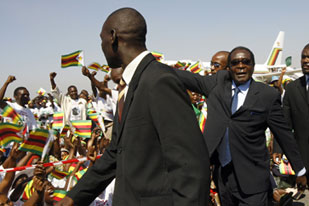 Mugabe, right, held on to power after a widely discredited election in June [AFP]