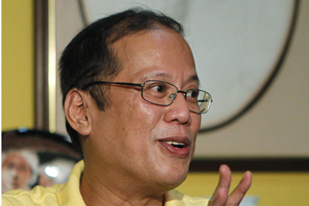 Philippine Senator Benigno "NoyNoy" Aquino III gestures as he speaks during a news conference at his residence in Quezon City, Metro Manila