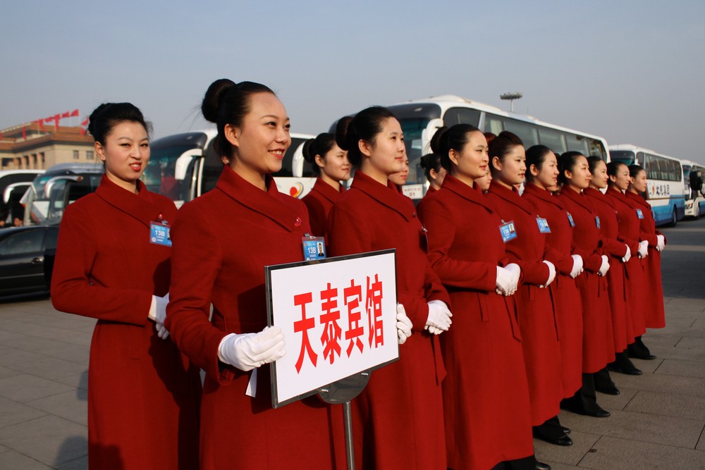 A group of hostesses pose in front of buses at Tiananmen Square in Beijing. The congress will complete China(***)s leadership transition that began with a Communist Party
congress in November 2012.