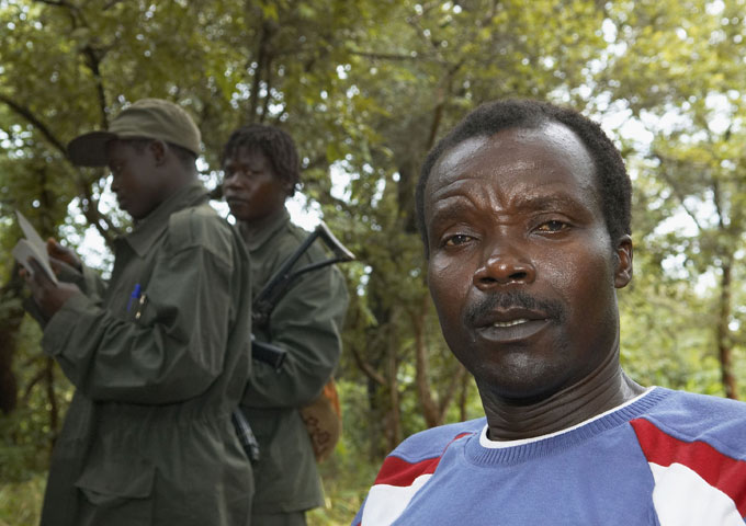Joseph Kony with armed soldiers standing in the background.