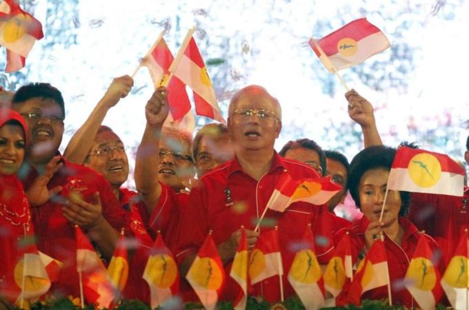 File photo of Malaysia''s Prime Minister Razak and party leaders of country''s ruling United Malays National Organization waving UMNO''s flags during 66th anniversary celebrations in Kuala Lumpur
