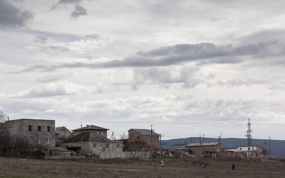 Children walk past houses in a poor area of Bakhchisaray, the historic capital of the Crimean Tatars in Crimea.