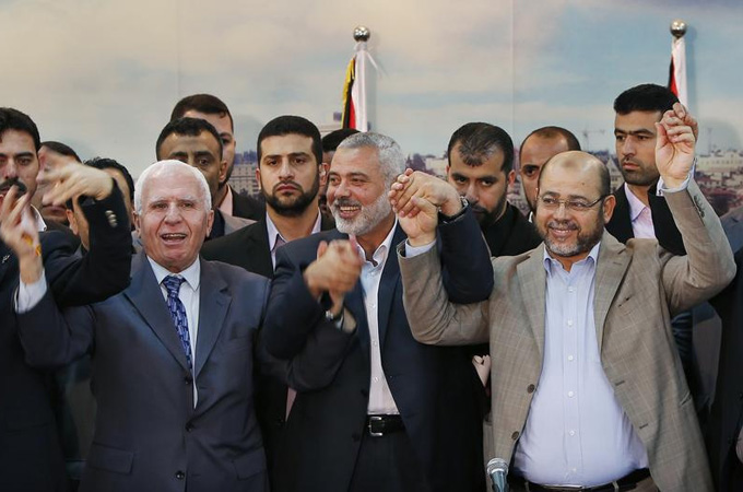Hamas and Fatah officials have signed an agreement, but many Palestinians are sceptical of the deal [Reuters]