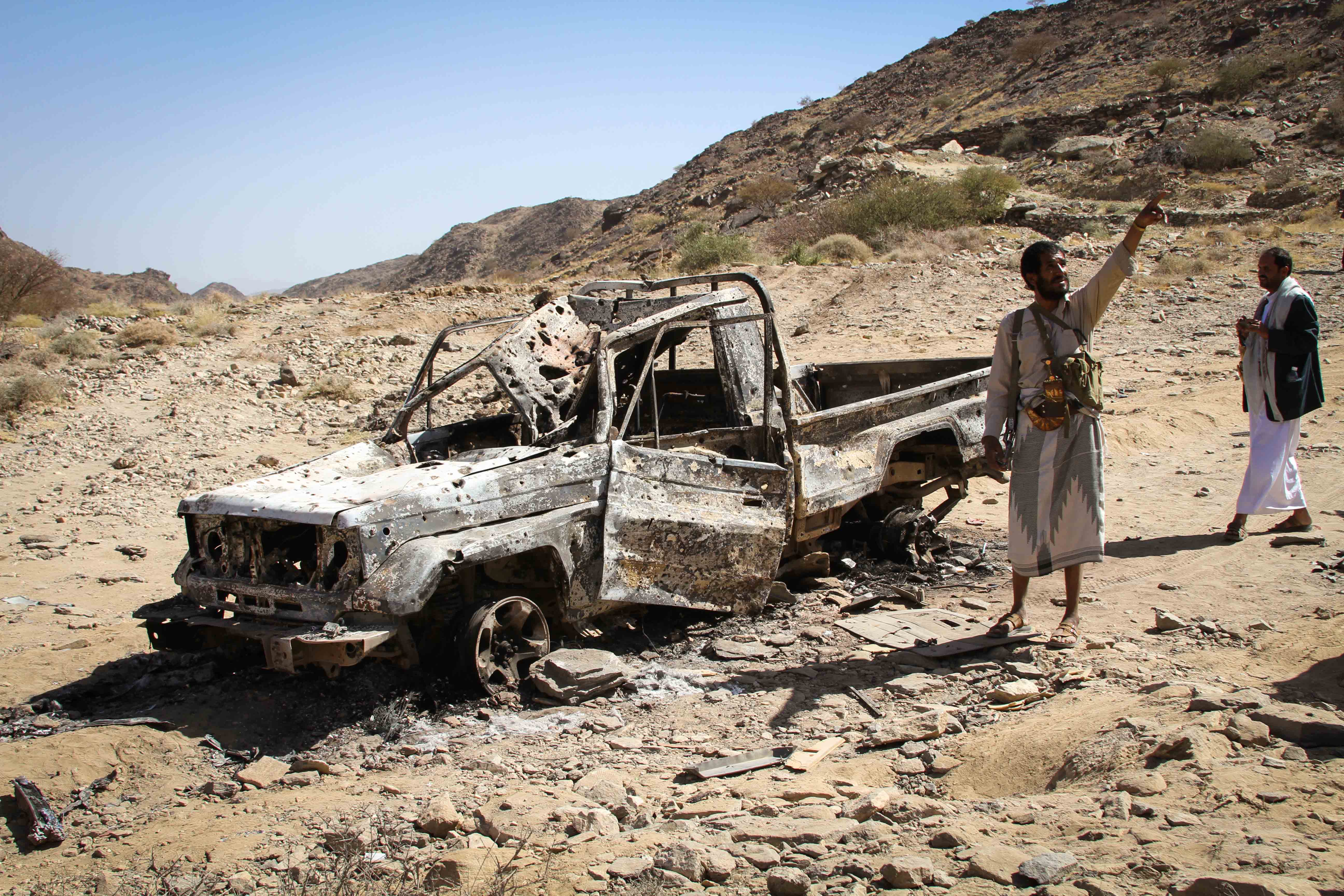 Mousid al-Taysi near a vehicle destroyed on December 12 in an alleged US drone strike [Rooj Alwazir/Al Jazeera]