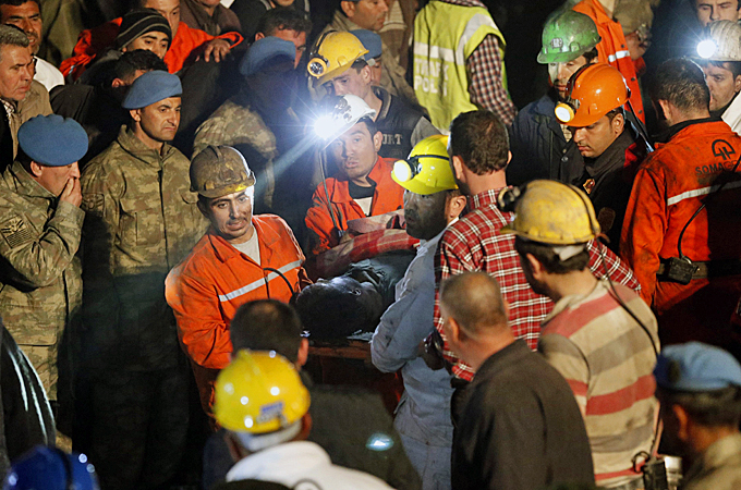 Rescue workers assist victims on Wednesday during a search for miners [AP]