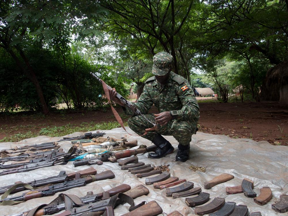 <p>A UPDF soldier checks weapons seized from LRA fighters during an operation.</p>