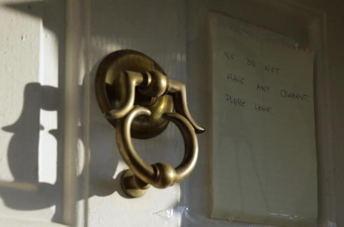 A note is shown on the door to the home of Johann Breyer, saying "no comment"  [AP]