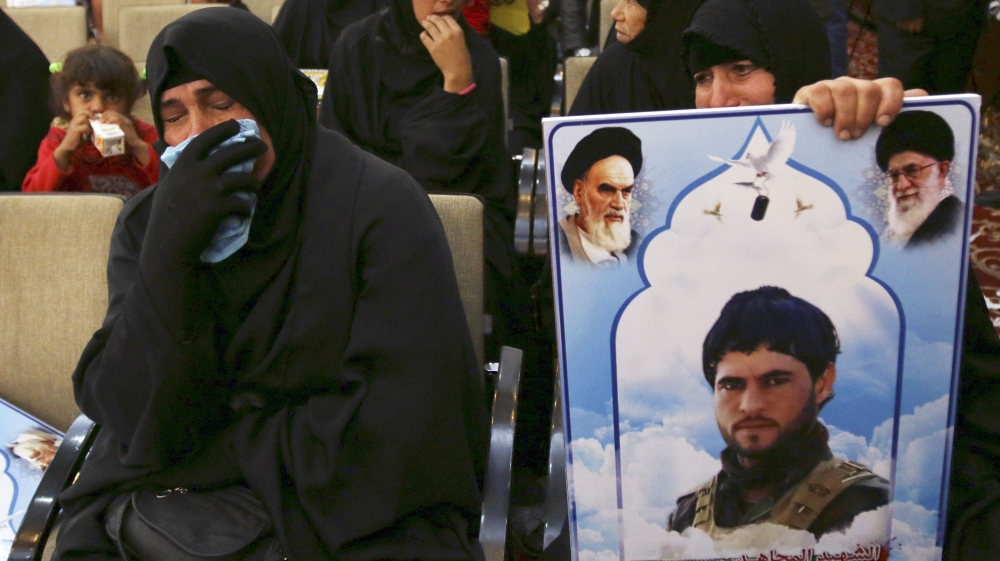 Women cry during a ceremony honouring fighters of the Iraqi Shi''ite militia group Saraya al-Khorasani who died during their fight against the Islamic State, in Baghdad