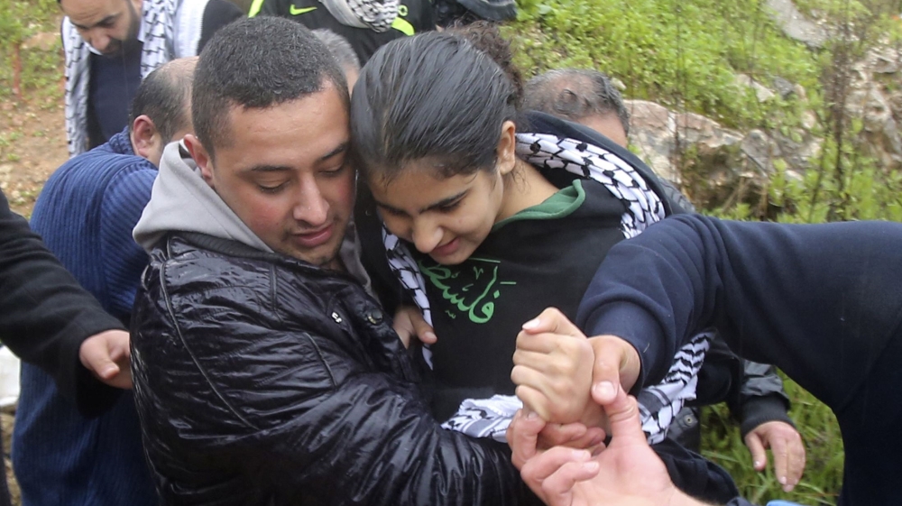 Palestinian schoolgirl Khatib is carried by a relative after her release from an Israeli jail at a checkpoint near Tulkarm