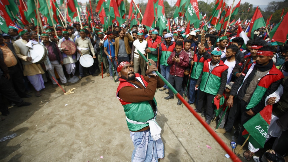 Protester performs stick dance during the mass demonstration demanding to draft the new constitution through consensus of all the political parties, in Kathmandu
