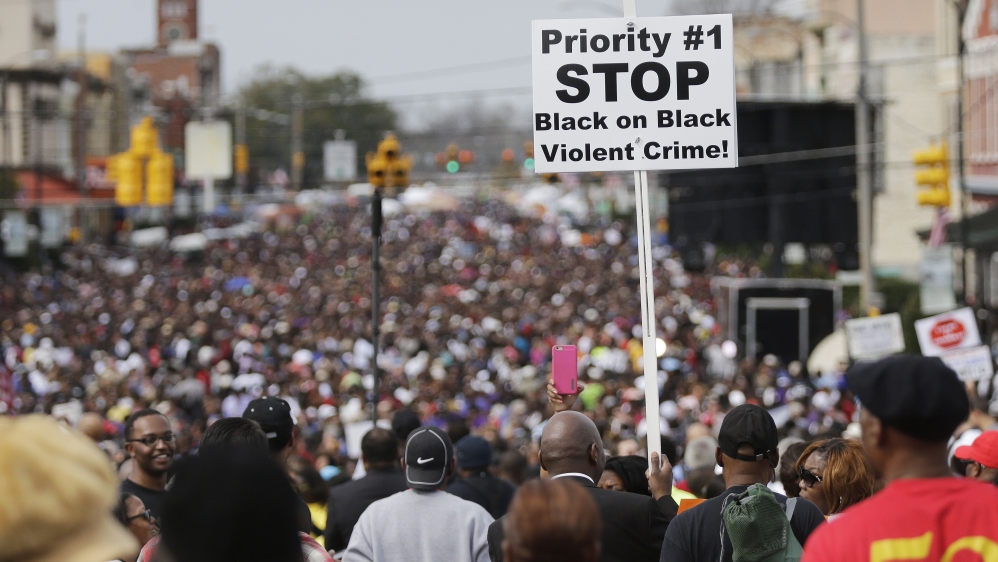Crowds of people walk toward Selma after taking a symbolic walk across the Edmund Pettus Bridge in Selma [AP]