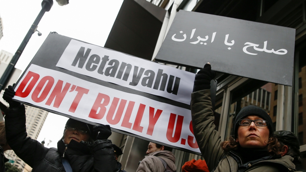 Demonstrators hold signs during a rally near the Israeli Consulate in New York