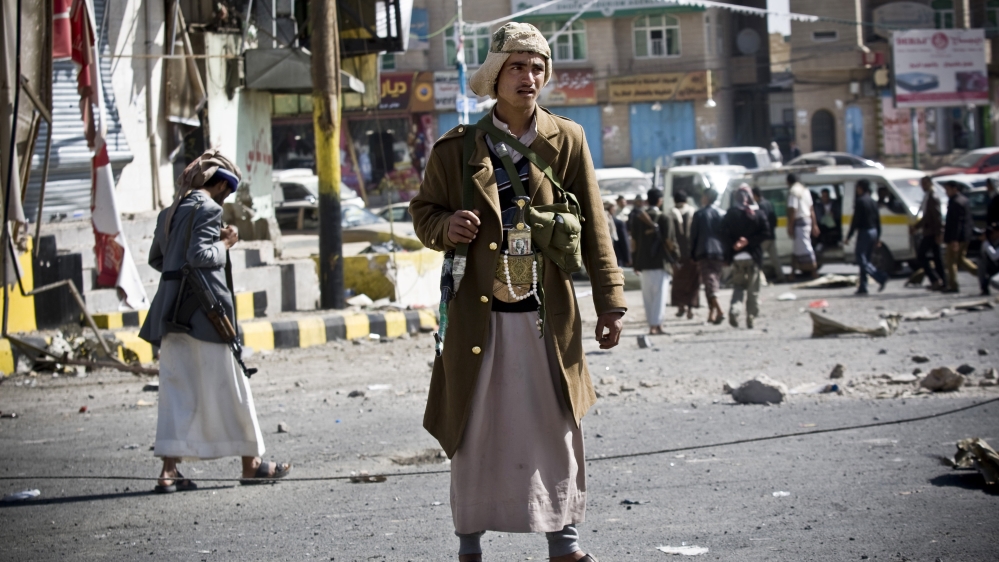 Houthi Yemenis gather while guarding a street leading to the presidential palace in Sanaa, Yemen [AP]
