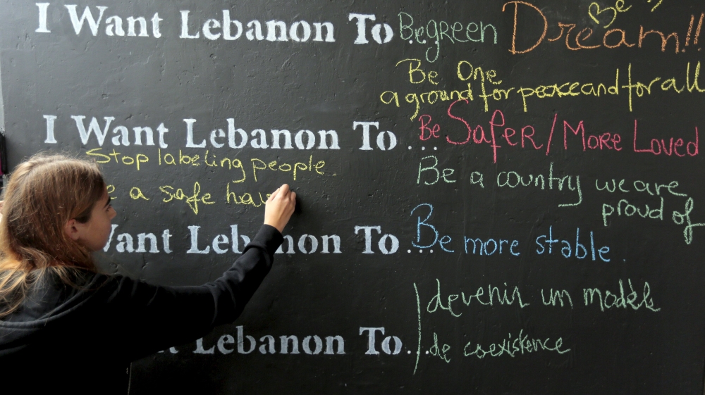 A Lebanese student writes on a wall during an event to mark the 40th anniversary of Lebanon''s civil war [REUTERS]