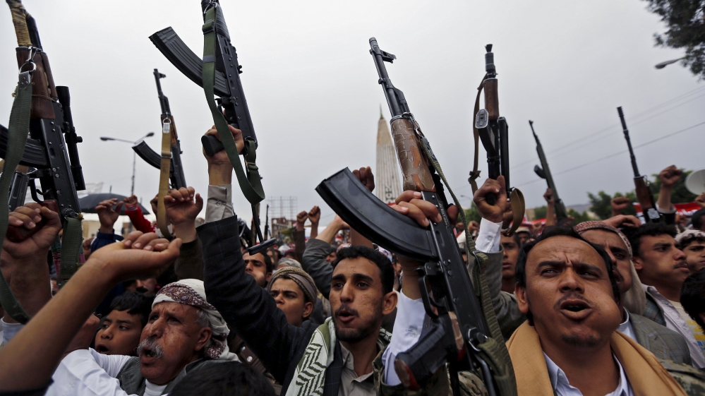 Houthi followers hold up their weapons during a demonstration against the Saudi-led air strikes, in Sanaa