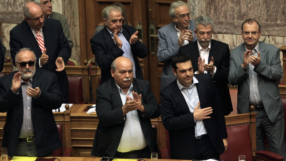 Tsipras is applauded by the members of the cabinet after his speech, during a debate on the referendum in the plenary session at the Greek Parliament in Athens [EPA]
