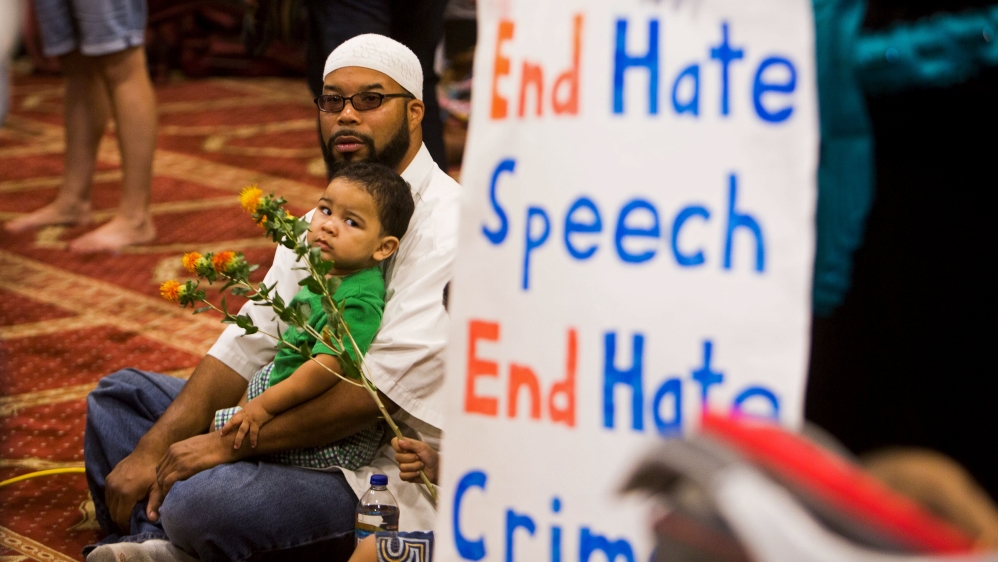 Attendees listen as speakers from different faiths speak at an interfaith rally titled "Love is Stronger than Hate" at the Islamic Community Center in Phoenix, USA