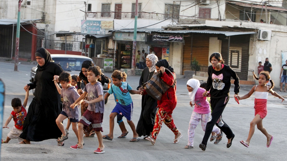 Palestinian residents flee Ain al-Hilweh Palestinian refugee camp, due to clashes in the area, near the port-city of Sidon, southern Lebanon