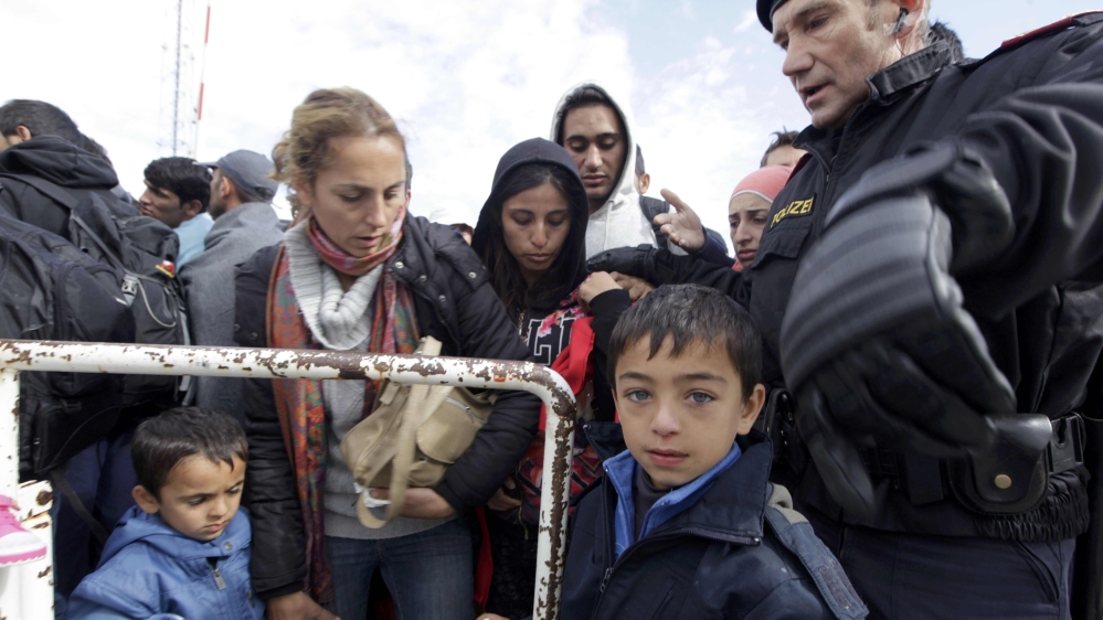 Migrants wait to board buses at Austrian border crossing of Nickelsdorf