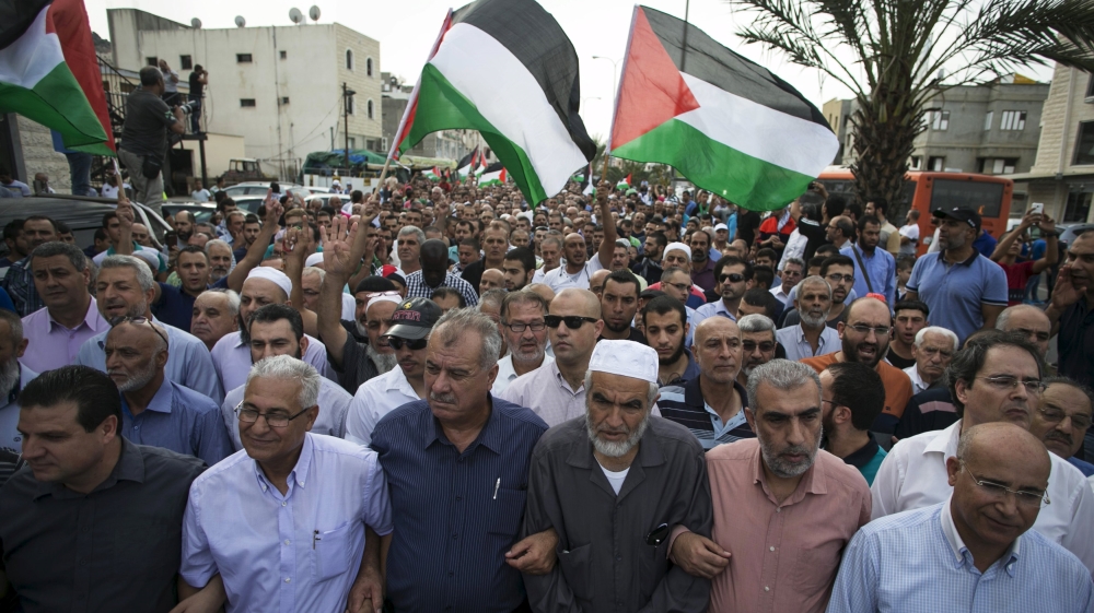 Head of the Joint Arab List Ayman Odeh joins others in a pro-Palestinian demonstration in the northern Israeli town of Sakhnin