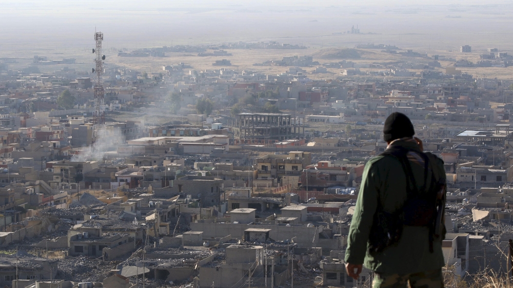 Member of the Kurdish Peshmerga forces stands in the town of Sinjar, Iraq