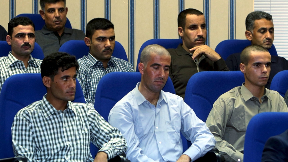 Hostages who have been freed by Peshmerga Special Forces and U.S. forces listen to Iraqi Kurdish Regional President Massoud Barzani in Arbil