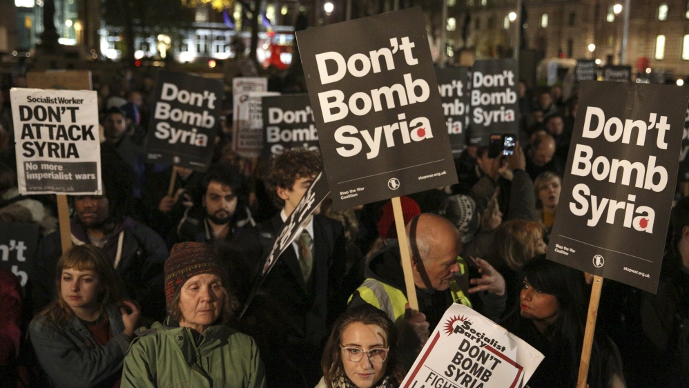 Anti-war protesters demonstrate against proposals to bomb Syria outside the Houses of Parliament in London, Britain
