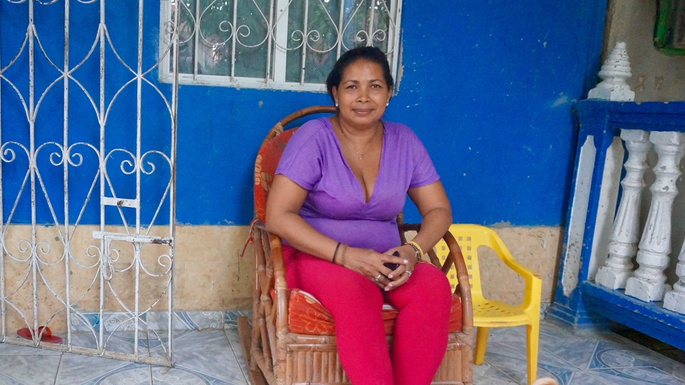 
Eidanis sits on the terrace of her house. Her home is being renovated to include a second floor to create more room for her family [Julia Zulver/Al Jazeera]

