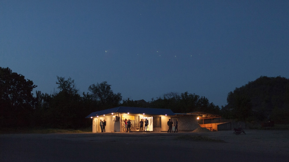 This is the only shop in the mining community of Davidovka and in the evenings it doubles up as the area's only bar. [Janos Chiala and Tali Mayer/Al Jazeera]  