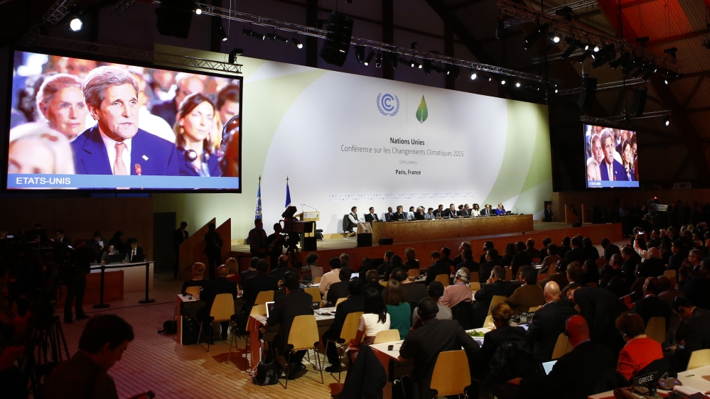 US Secretary of State John Kerry appears on television screens during the final conference at the COP21 [AP]