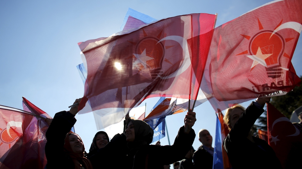 Turkish AK Party supporters wave flags as they wait for the arrival of Turkish Prime Minister Davutoglu in Istanbul