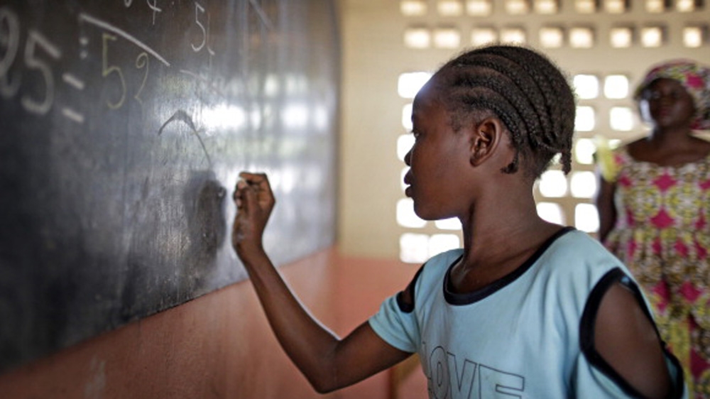 A girl working out sums at the blackboard during a math lesson at the refugee camp ''St Sauveur'' in Bangui, Central African Republic [Getty]
