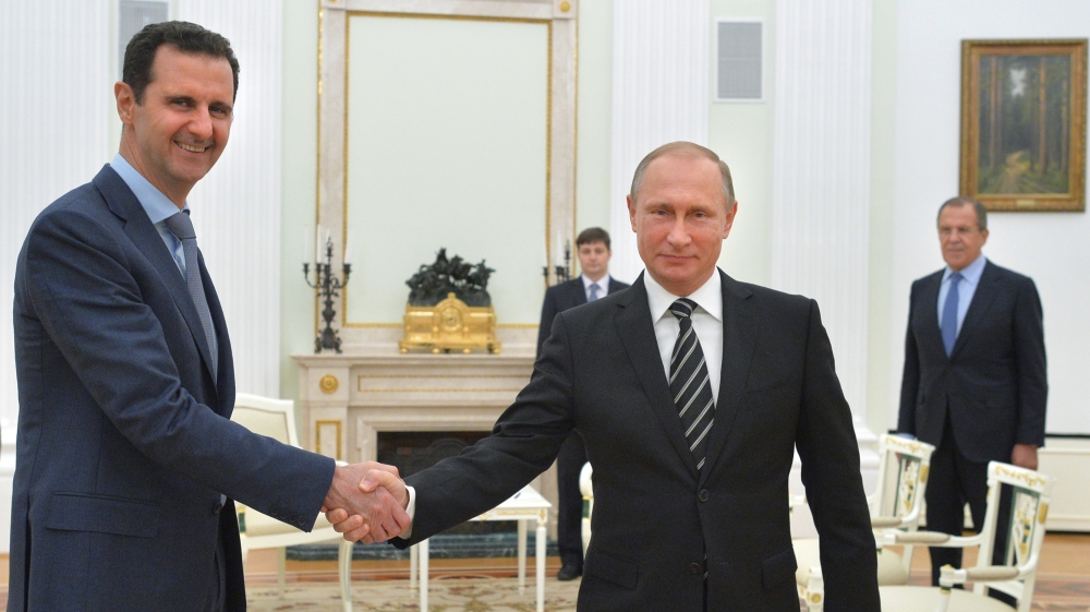 Russian President Vladimir Putin shakes hands with Syrian President Bashar Assad in 2015 [AP]