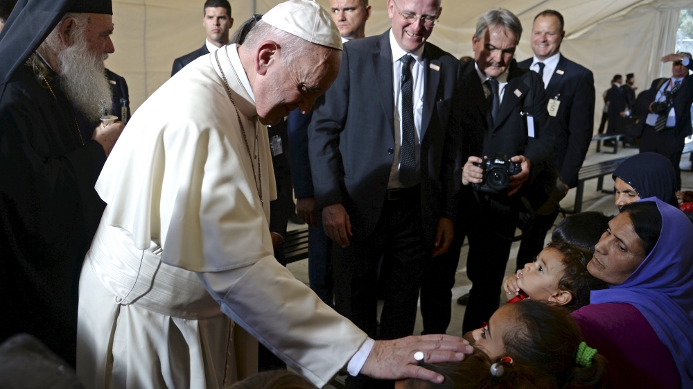 Pope Francis greets migrants and refugees at the Moria refugee camp near the port of Mytilene, on the Greek island of Lesbos