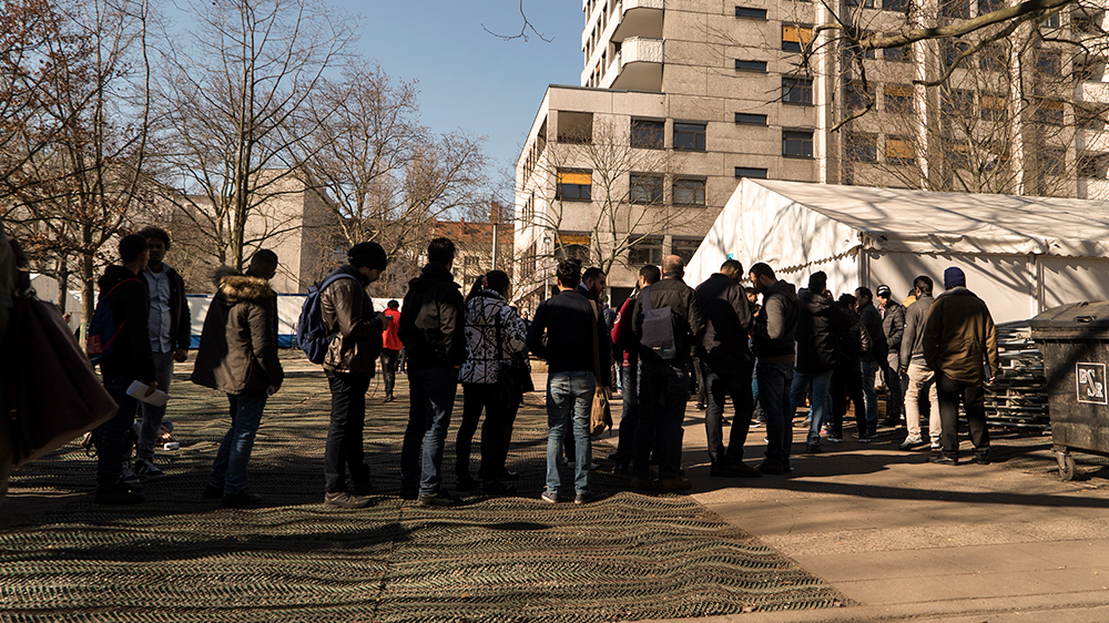 Refugees at State Office for Health and Social Affairs in Berlin [ Sorin Furcoi/Al Jazeera]