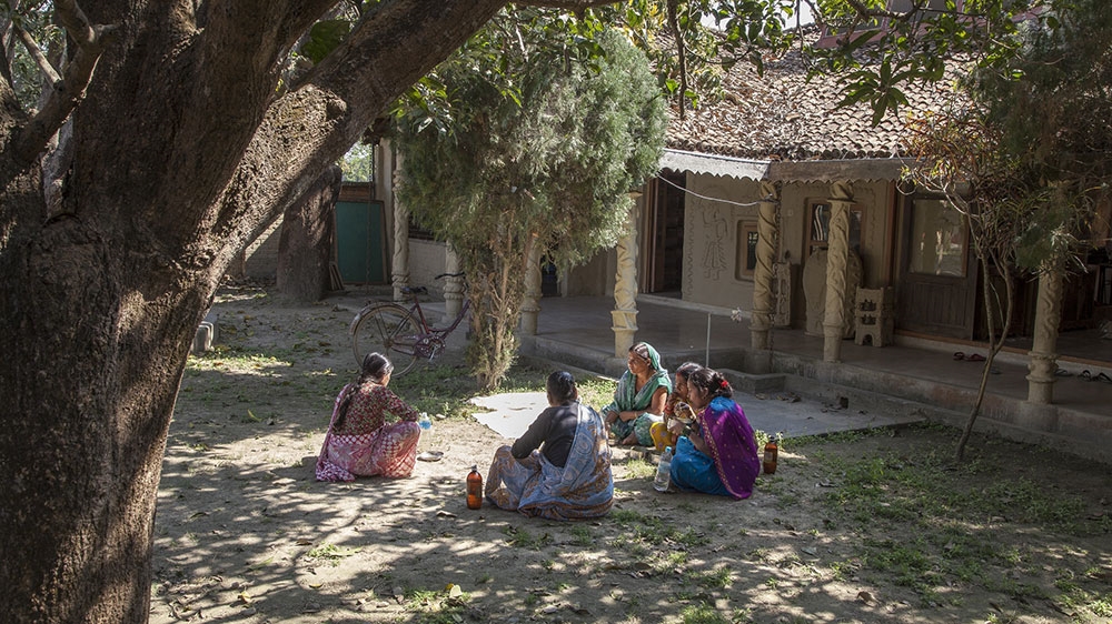 Maithil women take a break for lunch on the grounds of the Janakpur Women's Development Centre where they work near Janakpur, Nepal [Omar Havana/Al Jazeera]