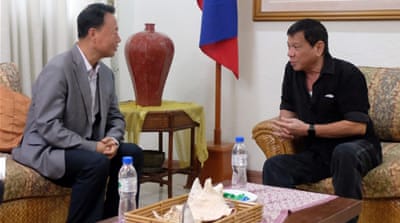 Filipino President-elect Rodrigo Duterte talking to Chinese envoy Zhang Jianhua during a meeting in Davao City.
