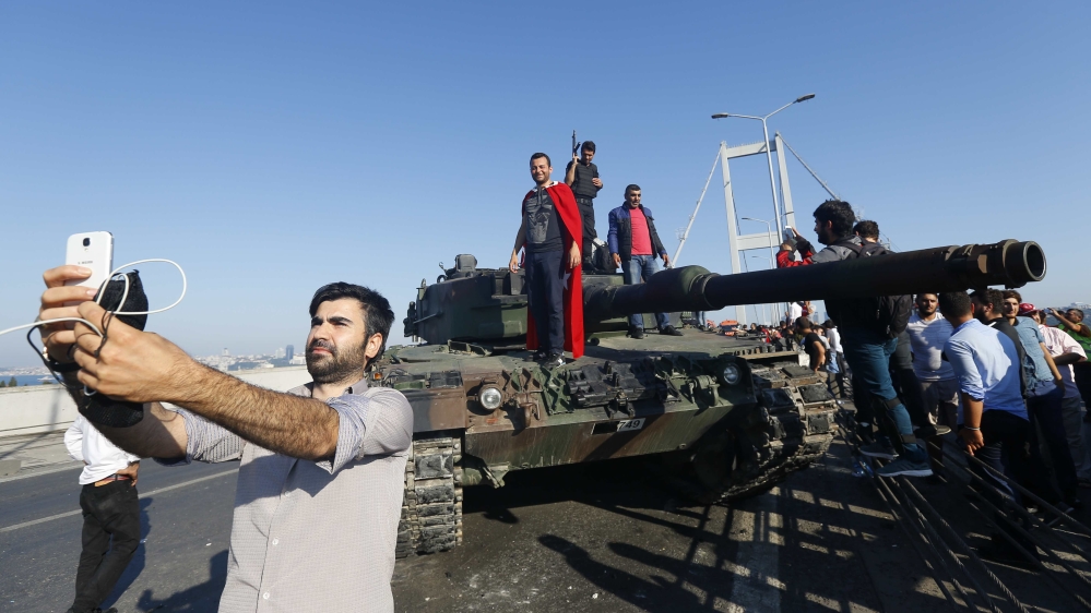 A man takes a selfie in front of a tank after troops involved in the coup surrendered on the Bosphorus Bridge in Istanbul