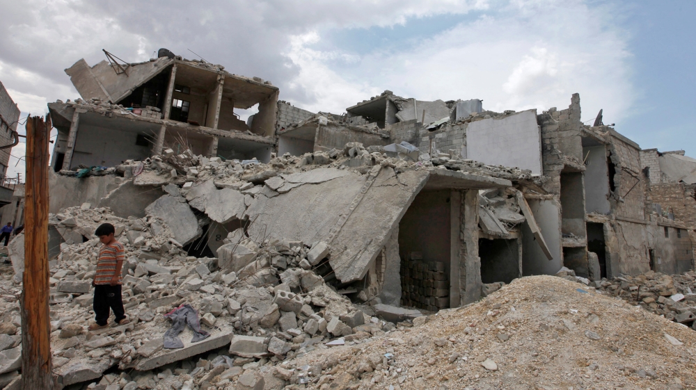 A boy stands near rubble and damaged buildings after what activists said was shelling by forces loyal to Syria''s President Bashar al-Assad, in Al-Tarrab neighbourhood near Aleppo International airport