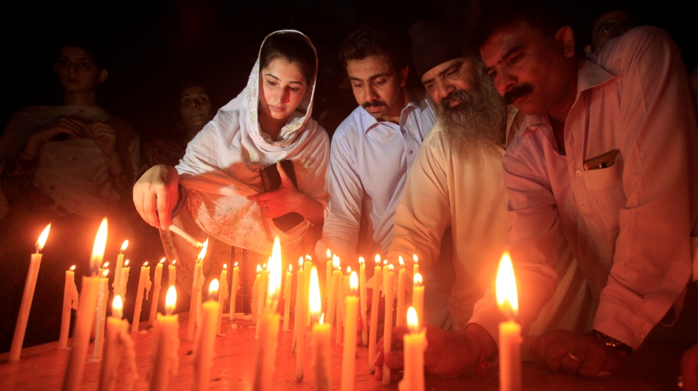 Residents light candles to honour victims of the blast in Quetta during a candellight vigil in Peshawar