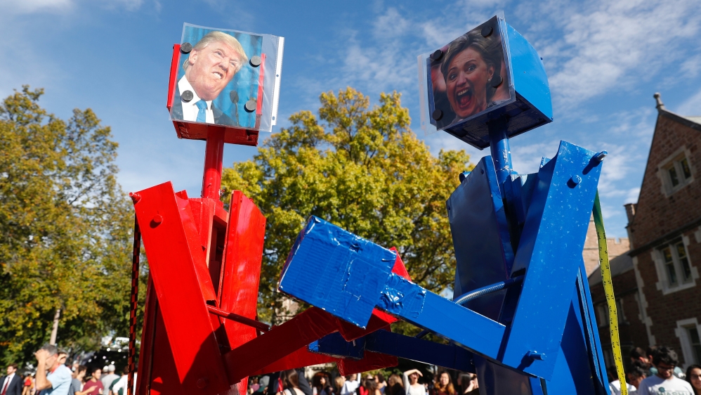 Robots with portraits of Trump and Clinton before the presidential debate in St. Louis, Missouri, US [REUTERS]