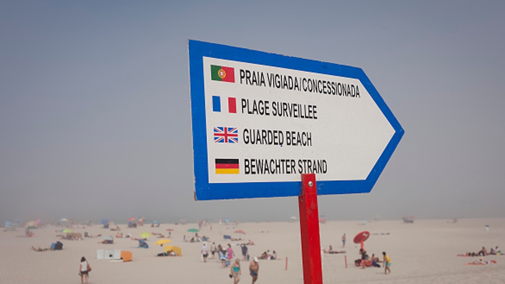 A warning sign in four languages telling sea swimmers of the dangers on a Portuguese beach [Getty]