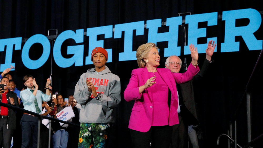 U.S. Democratic presidential nominee Hillary Clinton takes the stage with musician Pharrell Williams and U.S. Senator Bernie Sanders at a campaign rally in Raleigh