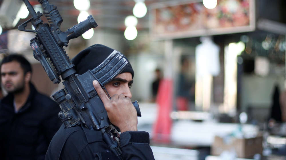 A member of the Iraqi Special Operations Forces (ISOF) stands guard at al Zohour area in Mosul