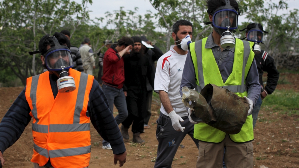A Civil Defence member carries a damaged canister in Ibleen village f