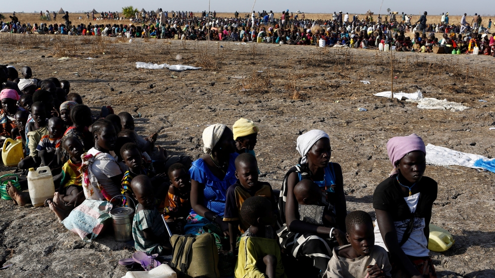 Women and children wait to be registered prior to a food distribution carried out by the United Nations World Food Programme (WFP) in Thonyor, Leer state