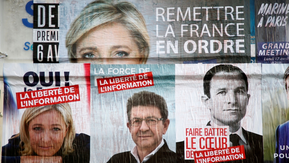 FILE PHOTO: Campaign posters for candidates Marine Le Pen of the National Front (FN), Jean-Luc Melenchon of the Parti de Gauche, and Benoit Hamon of the Socialist Party are seen in Paris