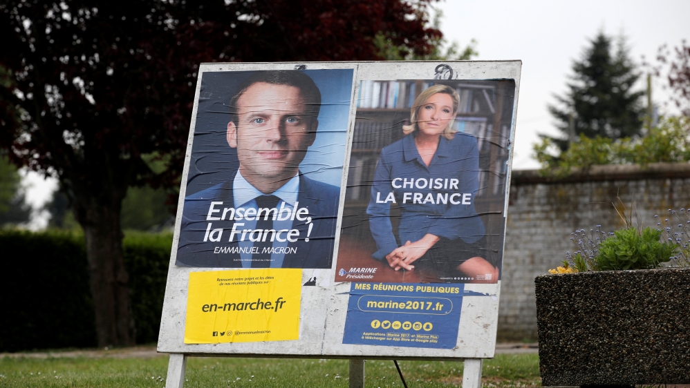 Official posters of the candidates for the 2017 French presidential election, Emmanuel Macron and Marine Le Pen are displayed in Sorrus