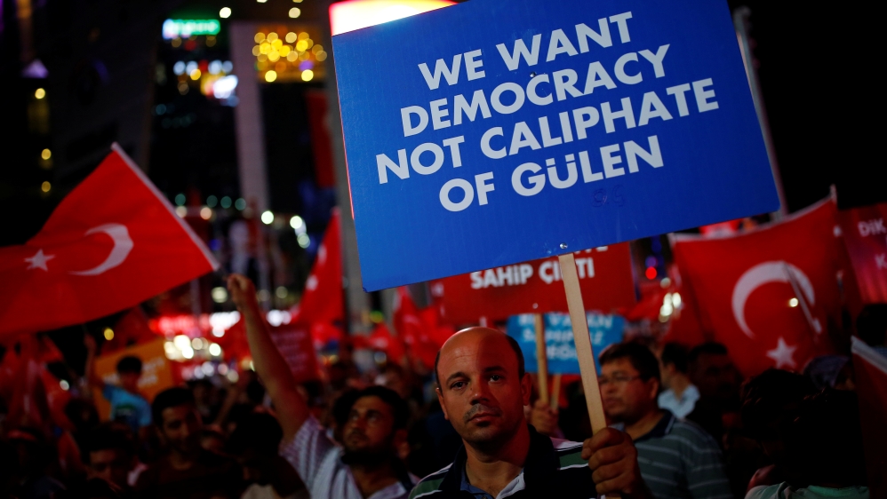 Supporters of President Erdogan wave Turkish flags as shirts hung on gallows are seen during a trial in Mugla