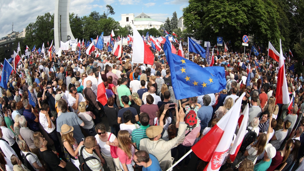 Protesters gather in front of the Parliament building during an opposition protest in Warsaw